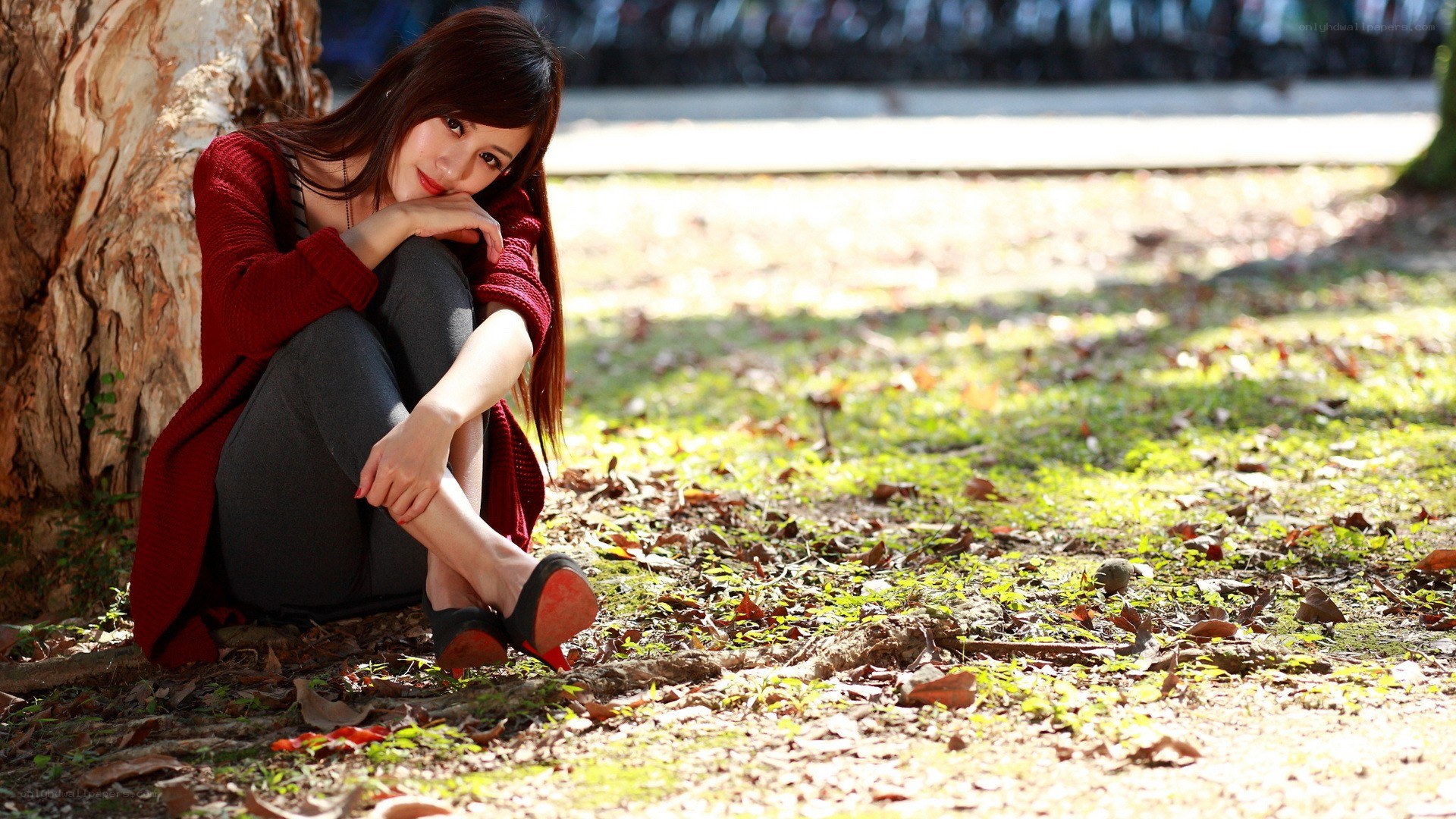 Woman sitting by a tree