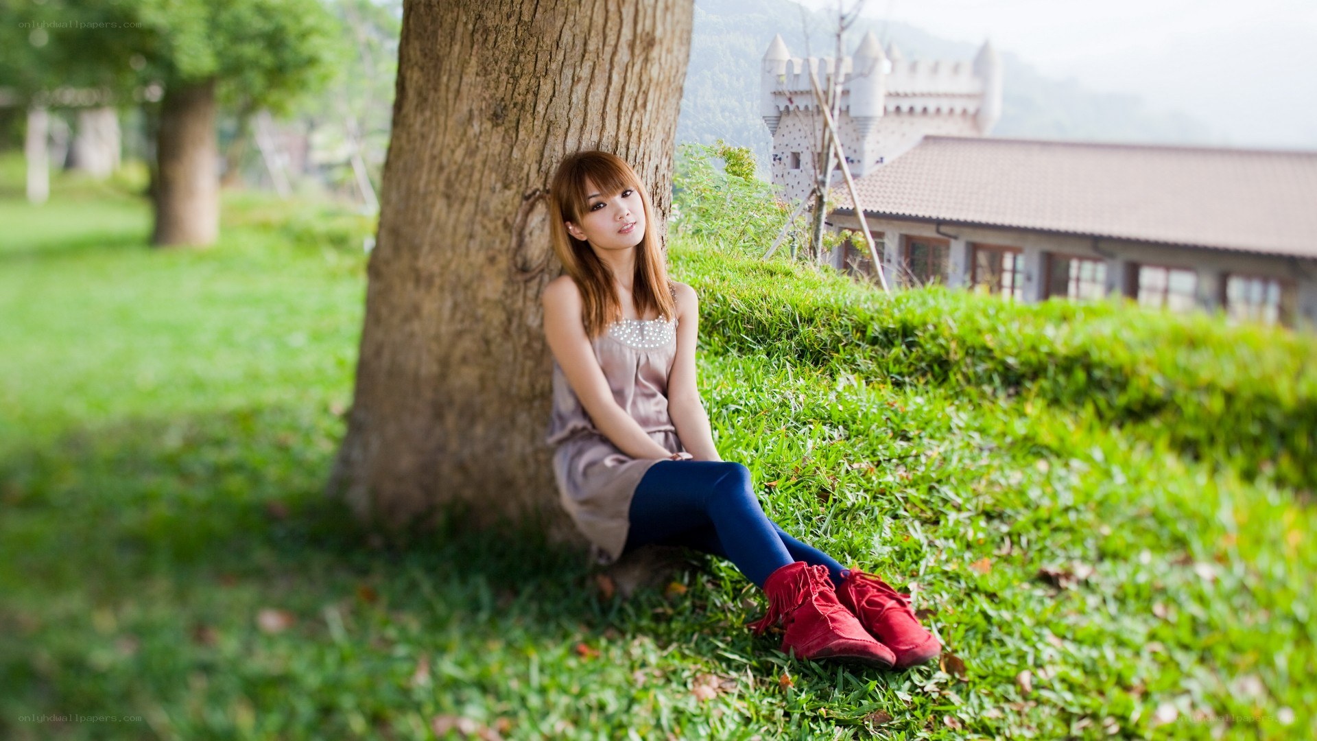 Woman sitting by a tree