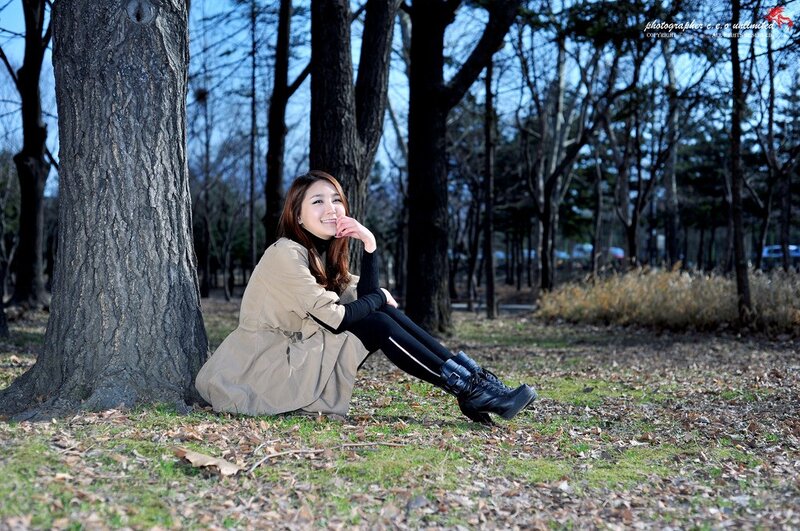Woman sitting by a tree