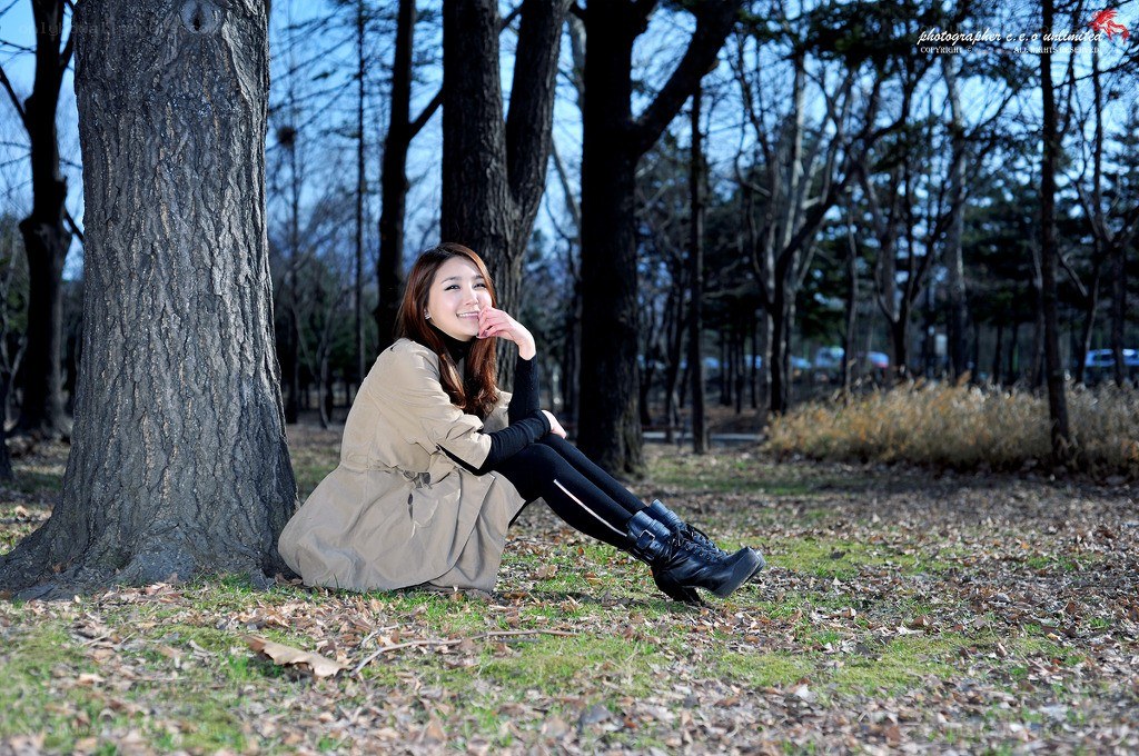 Woman sitting by a tree