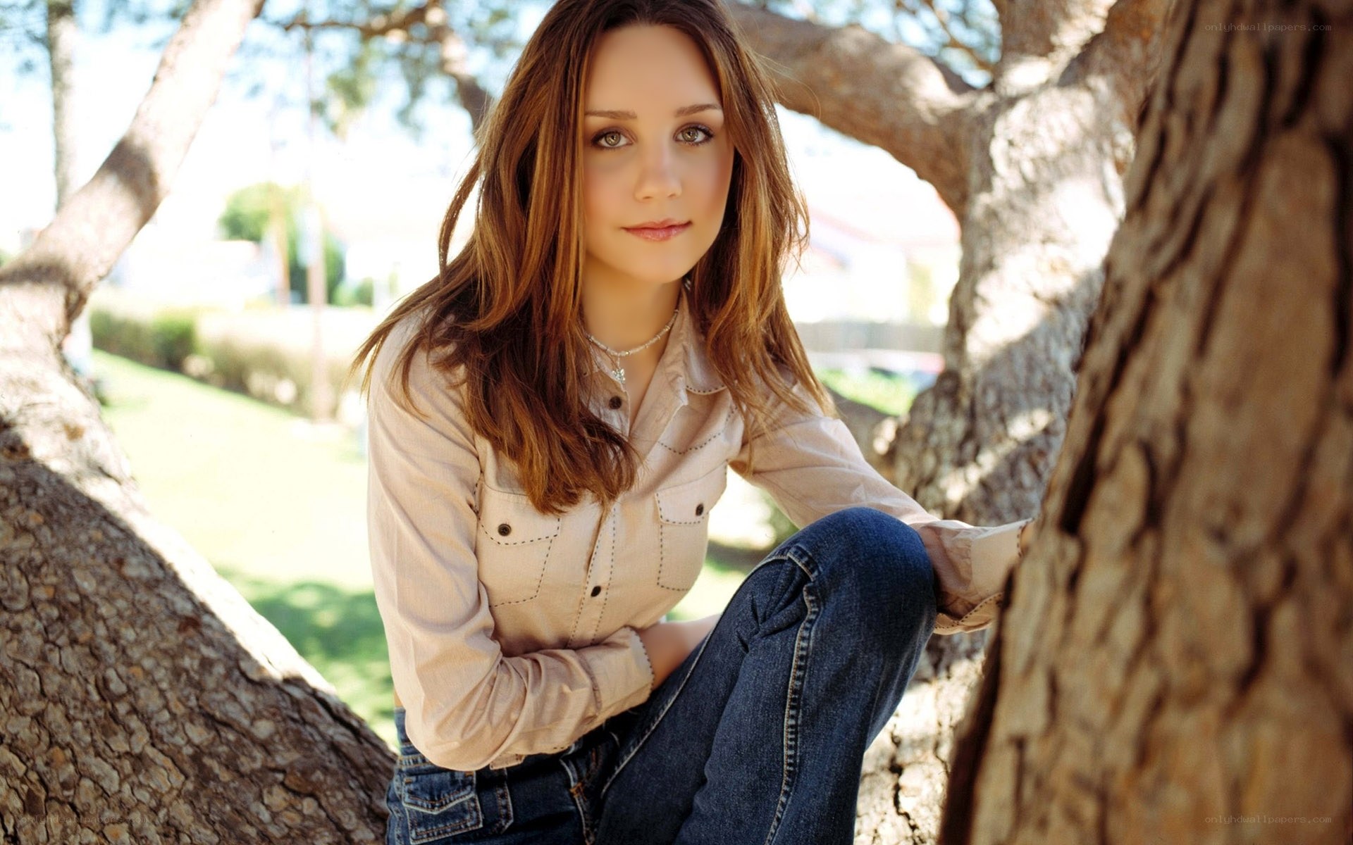woman sitting by a tree