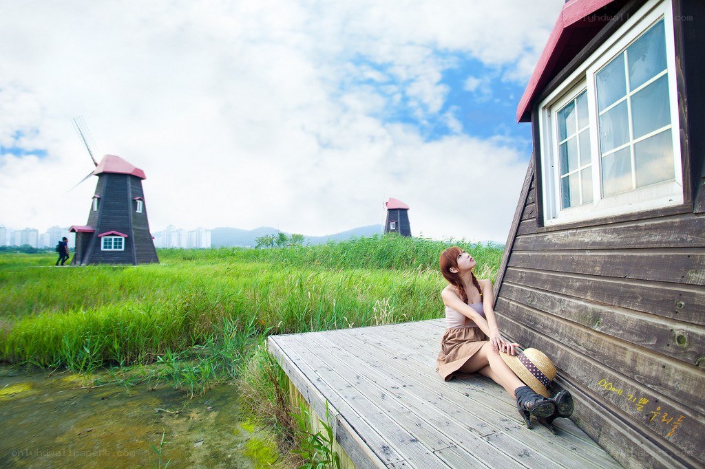 Woman sitting by a windmill