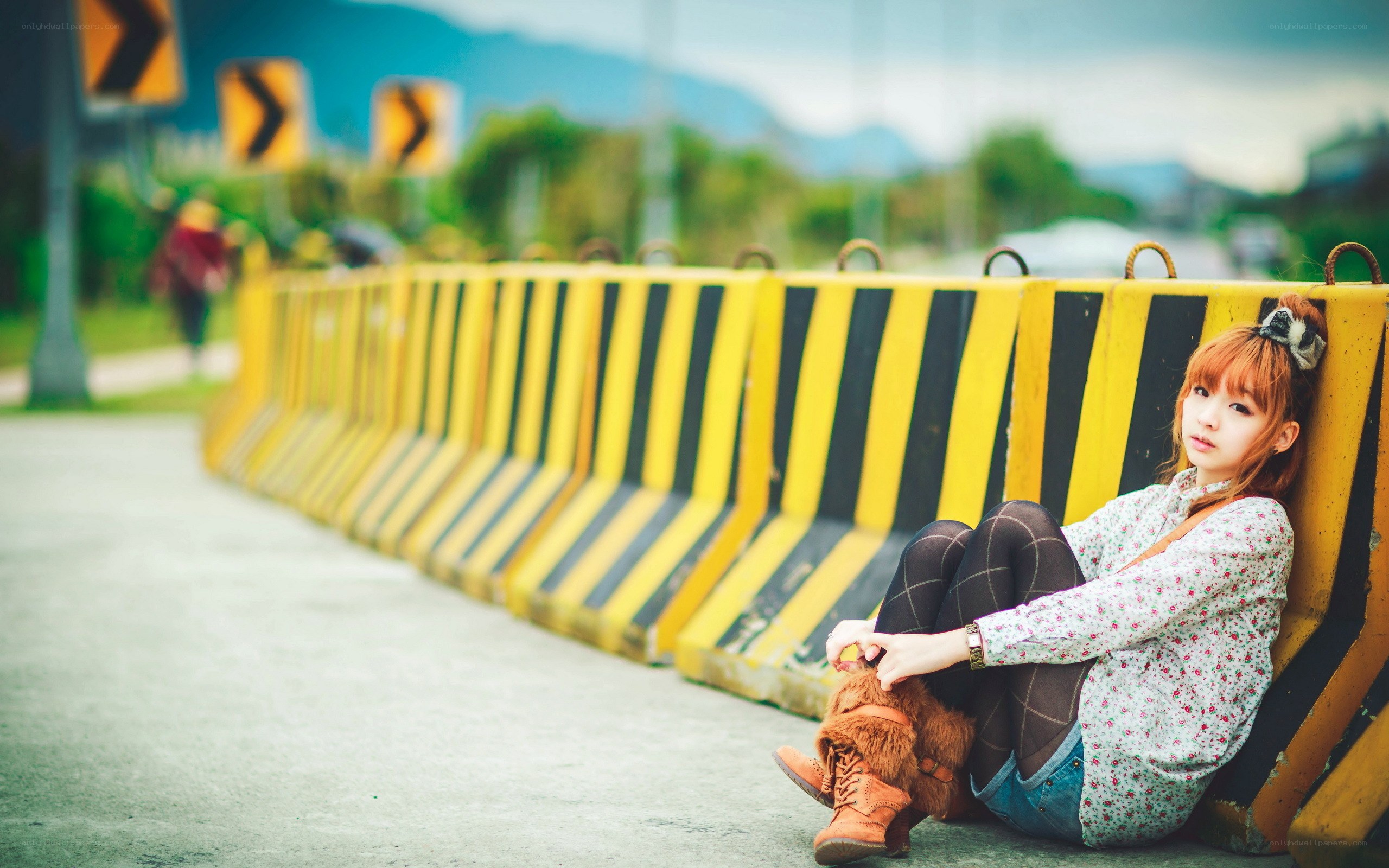 woman sitting by barrier