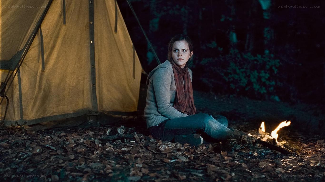 woman sitting by campfire