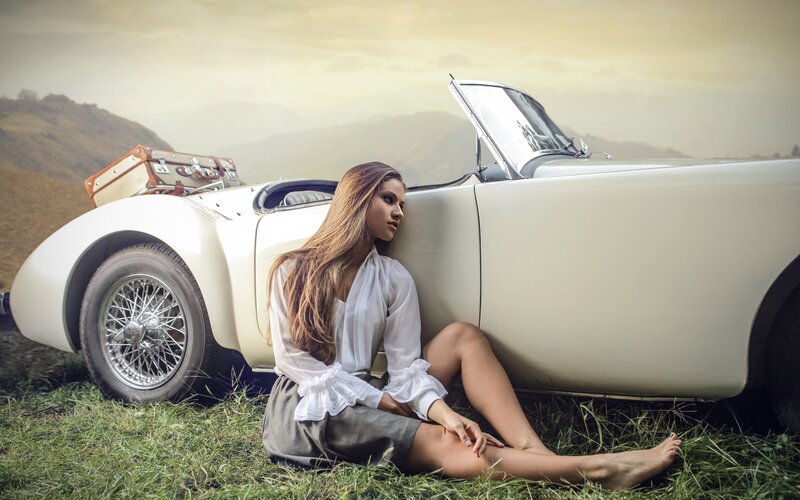 Woman Sitting by Car — White, Serene