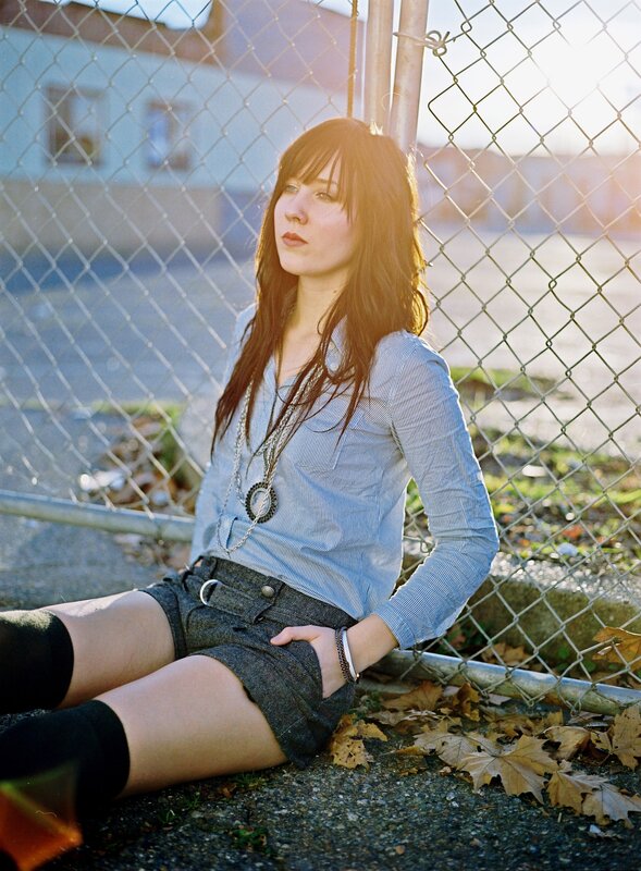 woman sitting by fence