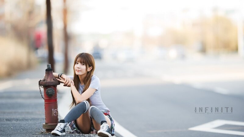woman sitting by fire hydrant