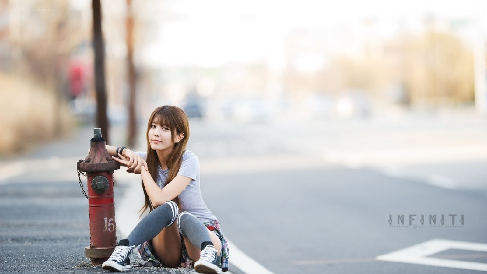 woman sitting by fire hydrant
