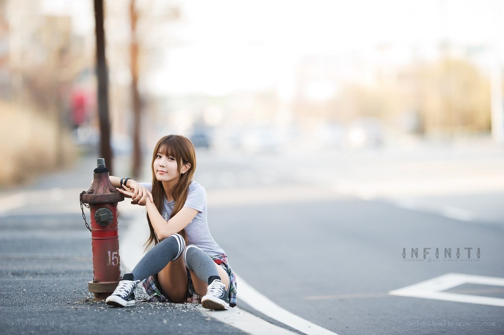 woman sitting by fire hydrant