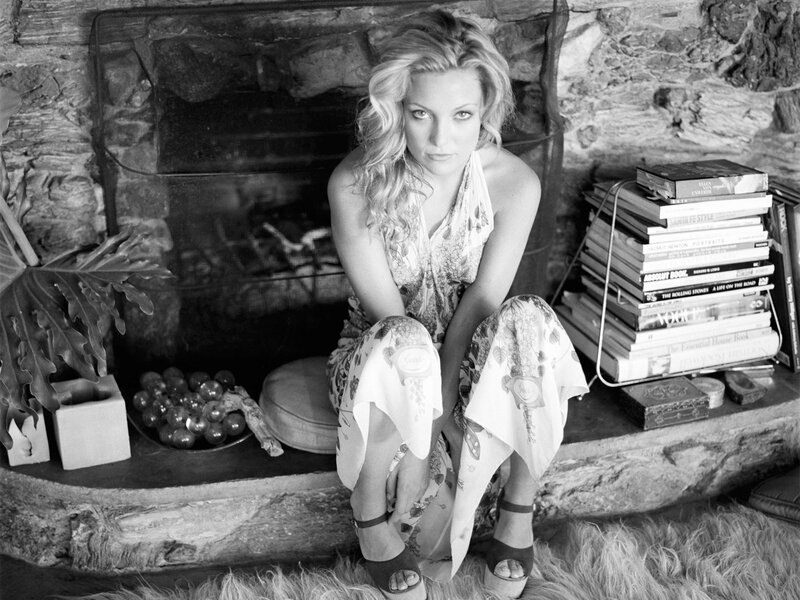 woman sitting by fireplace