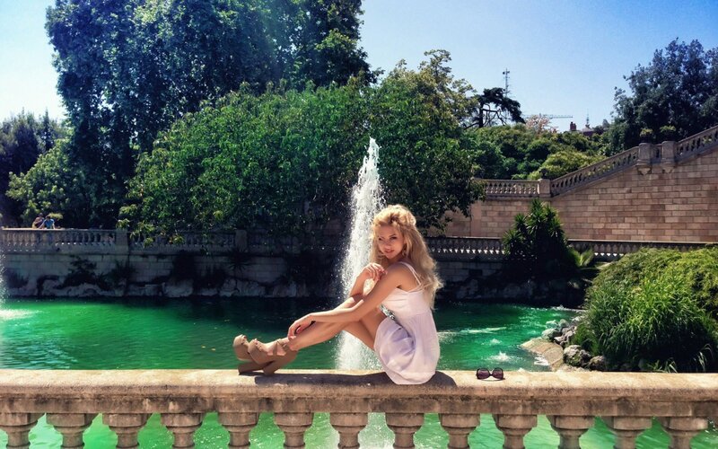Woman Sitting by Fountain — Green