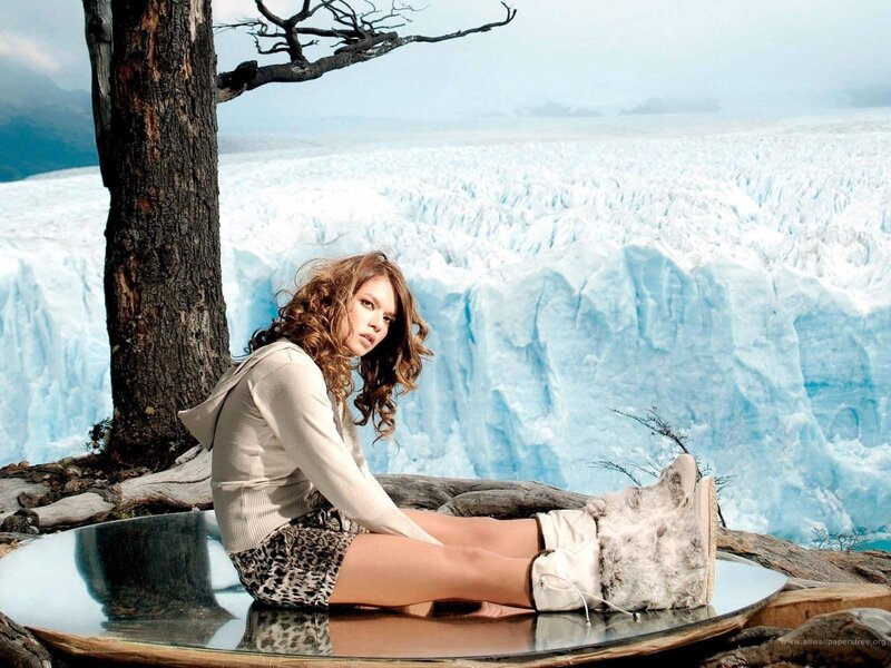 woman sitting by glacier