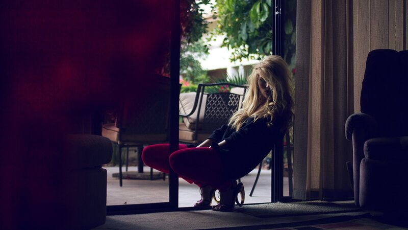 woman sitting by glass door