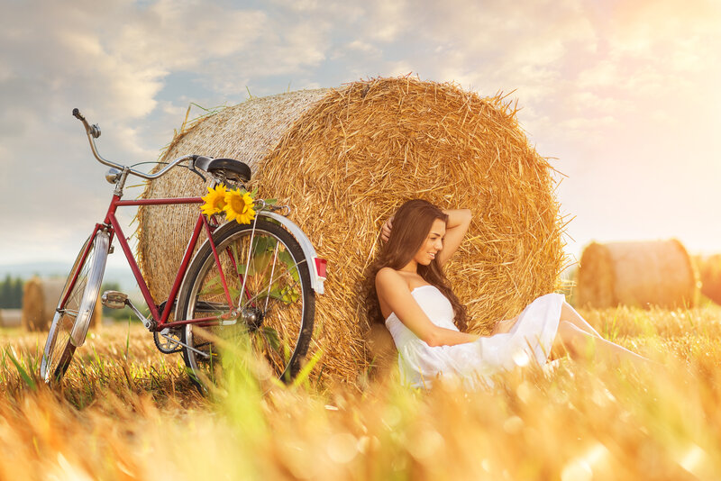 Woman Sitting by Hay Bale — Yellow
