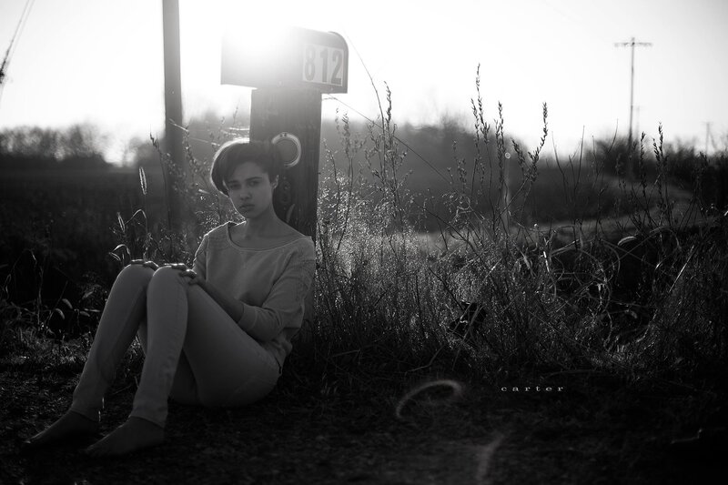 woman sitting by mailbox