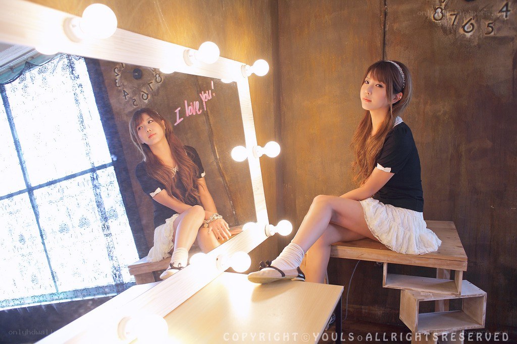 woman sitting by mirror