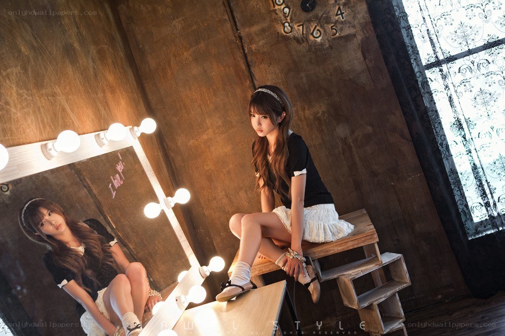 woman sitting by mirror