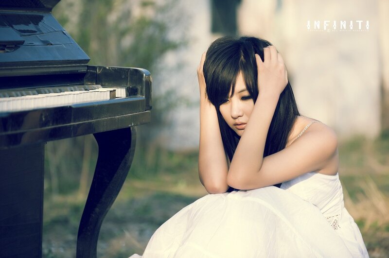 woman sitting by piano