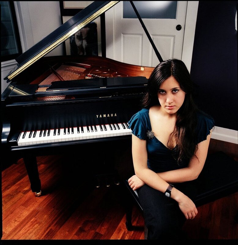woman sitting by piano