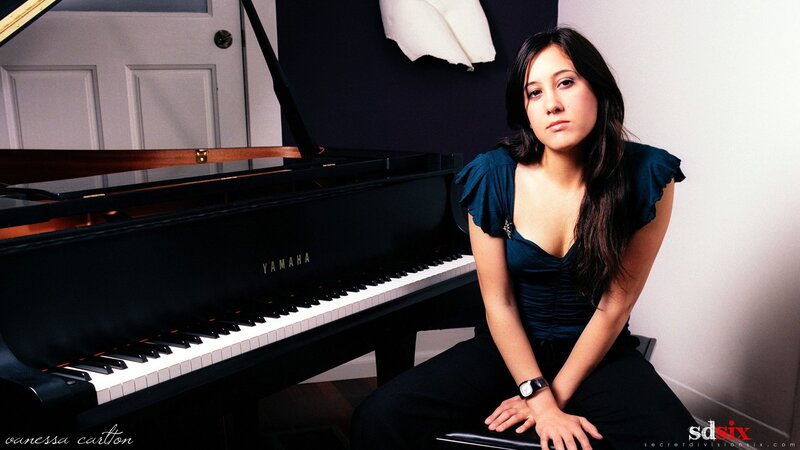 woman sitting by piano