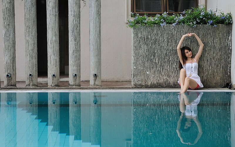 Woman Sitting by Pool — Blue, Calm, Afternoon