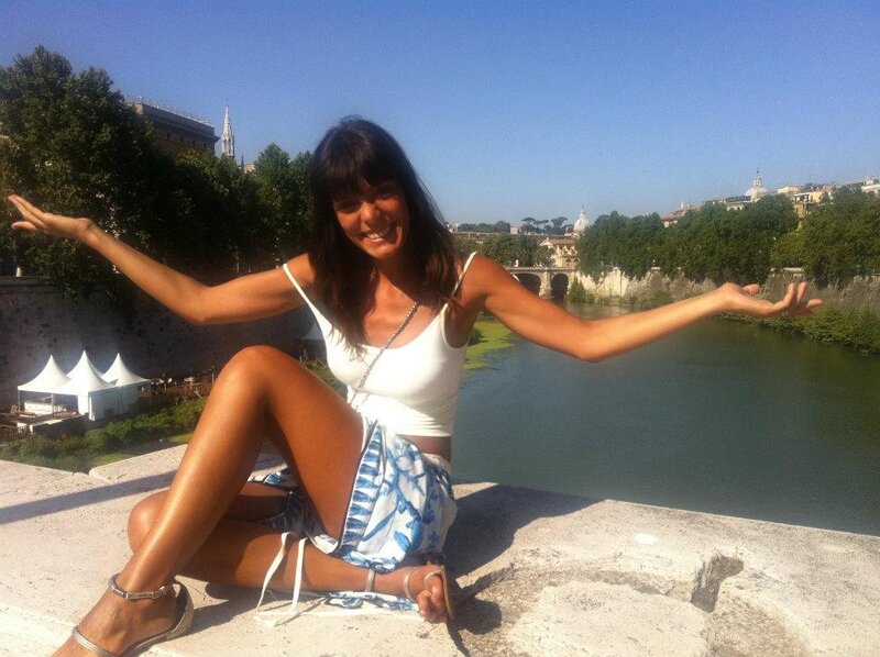 Woman sitting by river in Rome