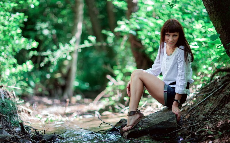 Woman Sitting by Stream — Green, Serene, Afternoon, Photograph