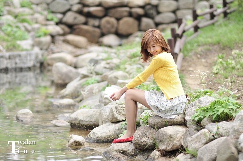 Woman Sitting by Stream — Yellow