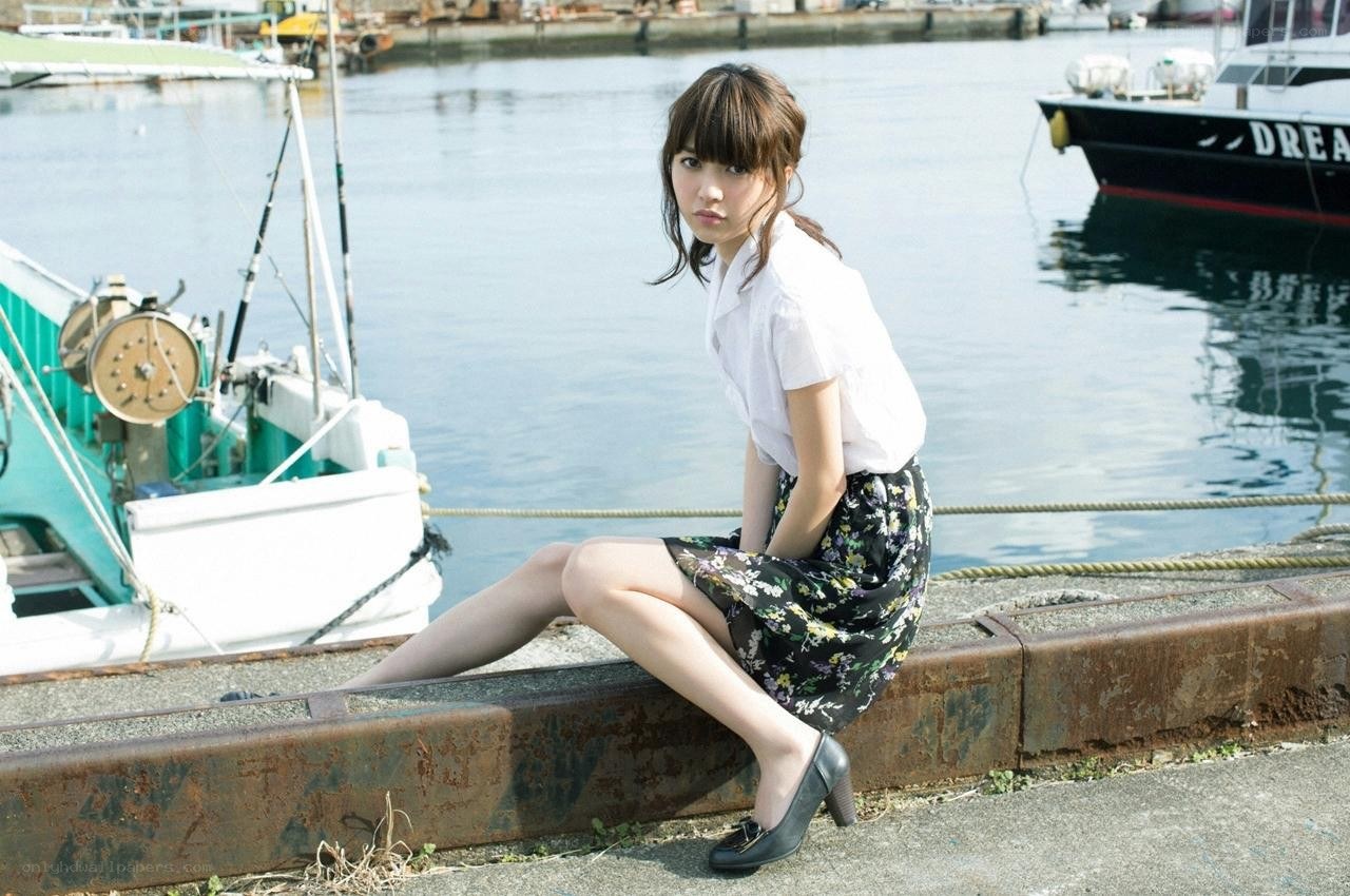 Woman sitting by the harbor