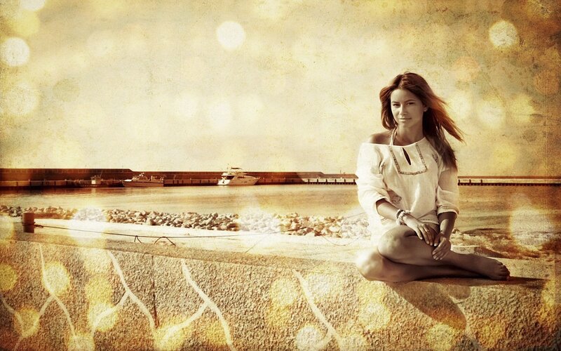 Woman sitting by the harbor