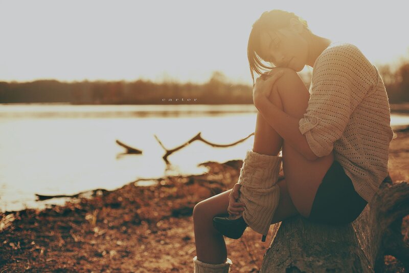 woman sitting by the lake