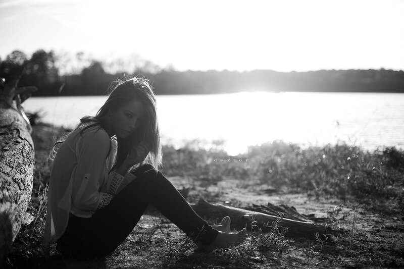 woman sitting by the lake
