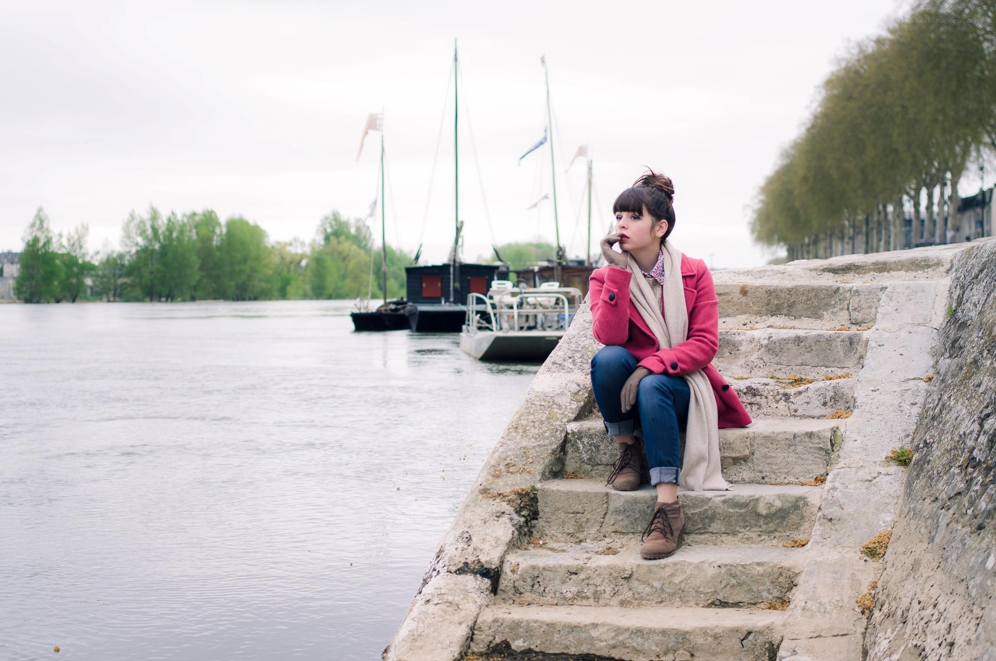 Woman sitting by the river