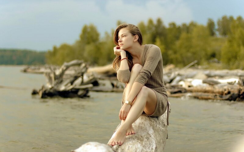 woman sitting by the river