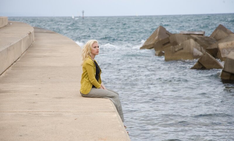 woman sitting by the sea