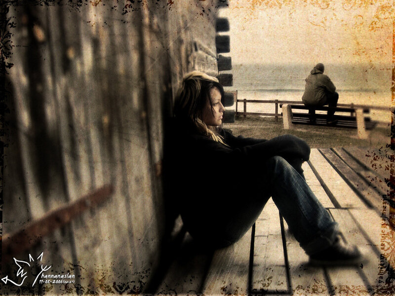 woman sitting by the sea
