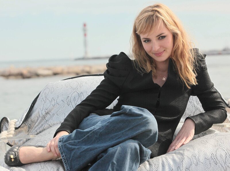 Woman sitting by the sea