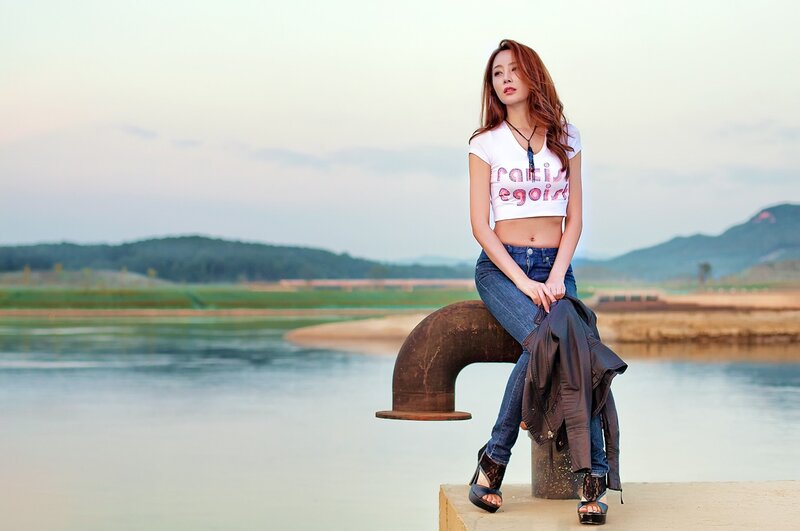 Woman sitting by the water