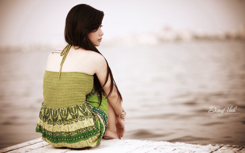 woman sitting by the water