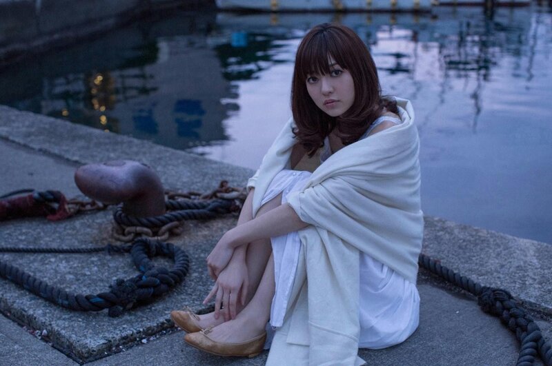 woman sitting by the water