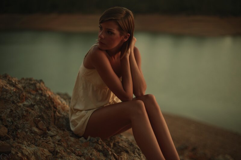 woman sitting by the water