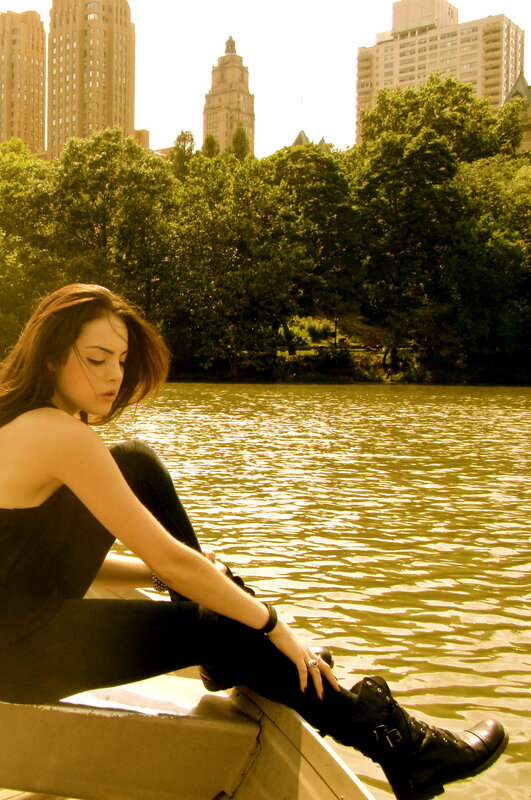 woman sitting by the water