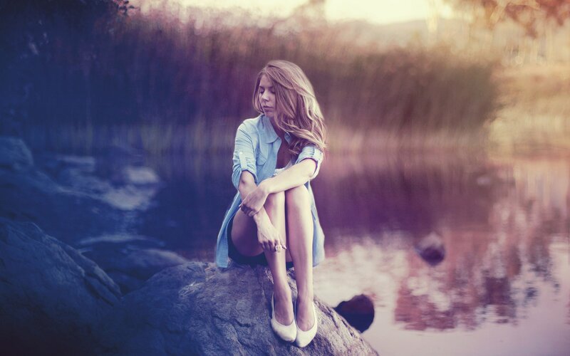 woman sitting by the water