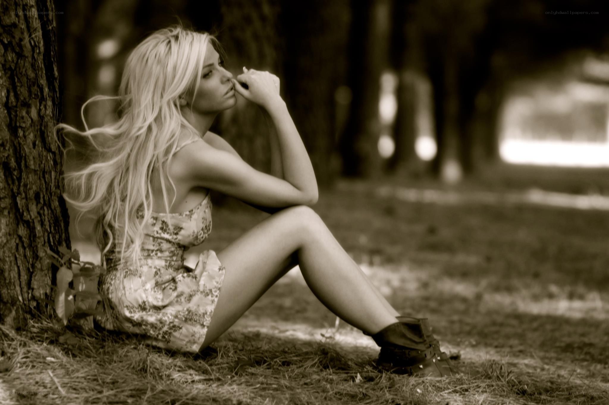 woman sitting by tree