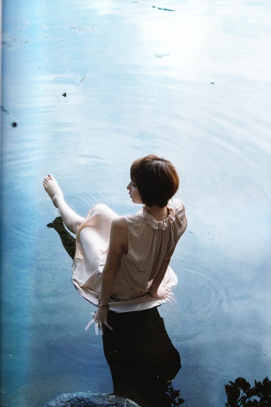 woman sitting by water