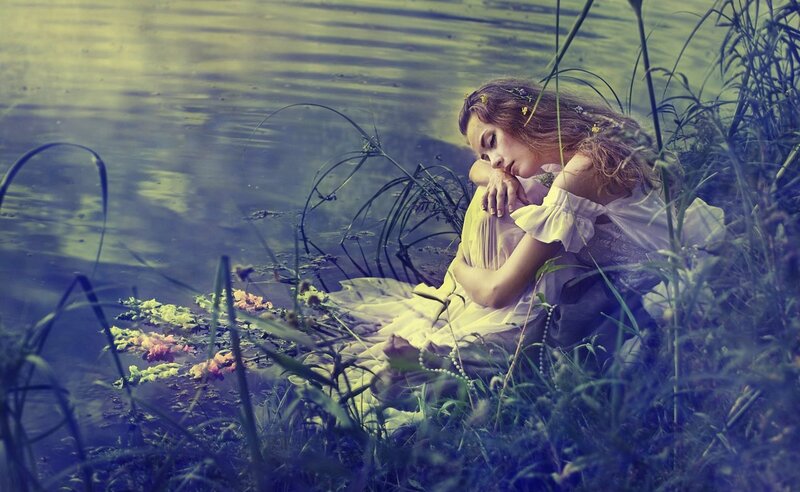 Woman Sitting by Water — Blue, Serene, Photograph