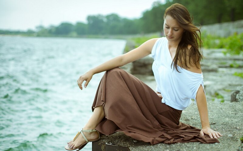 Woman Sitting by Water — Brown, Calm