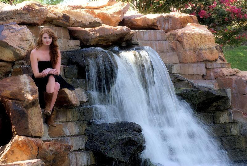 Woman Sitting by Waterfall — Brown, Serene