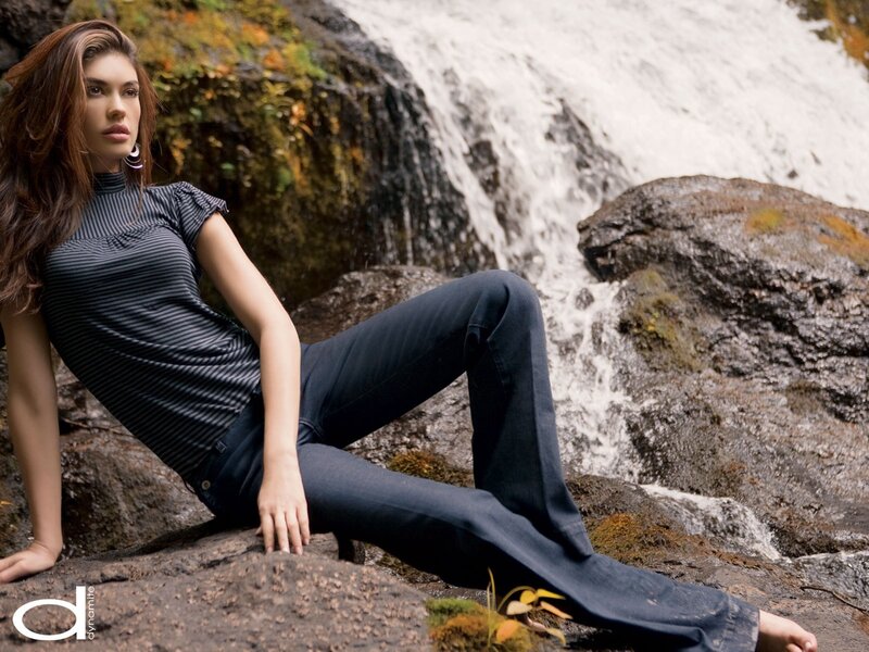 Woman Sitting by Waterfall — Gray