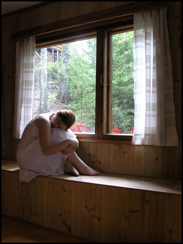 Woman sitting by window